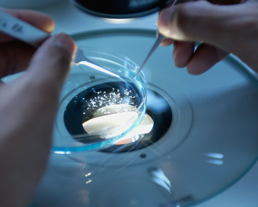 Close-up of a scientist handling stem cell samples in a modern lab.